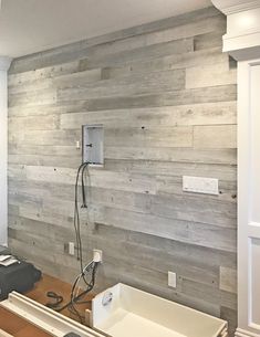 a room with wood paneling and electrical equipment on the counter top in front of it