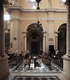 the inside of a building with many chairs