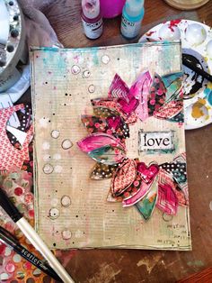 an art journal with some crafting supplies on the table