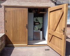 an open wooden garage door with a machine in it's center and side doors