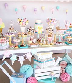 a birthday party with balloons, cake and decorations