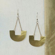 Both subtle and dramatic simultaneously. These brass semi-circle drop statement earrings easily add punch your outfit. They have a brushed finish for a modern sensibility, although we think there's a hint of a tribal design in there. They're one of those basic designed pieces you can't pigeon hole and that makes these earrings so wonderfully versatile. Details: Semi-circle drop statement earrings with hook back suitable for pierced ears. Size: Length of drop: ~ 3" (7.6 cm), width of widest part: ~1.4" (3.5cm) Material: Brass Modern Crescent Brass Earrings, Modern Brass Chandelier Earrings, Pigeon Hole, Drop Statement Earrings, Statement Drop Earrings, Pierced Ears, Pigeon, Ear Piercings, Statement Earrings