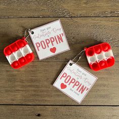 two red and white ice trays with valentine's day poppin on them