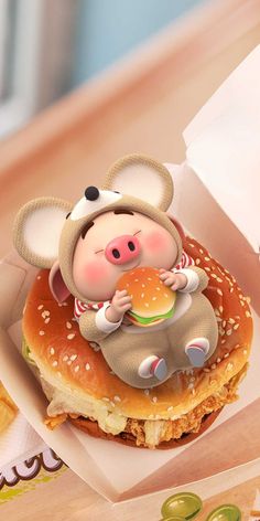 a small toy mouse sitting on top of a hamburger in a paper bag next to other food items