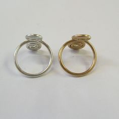 This listing is for a set of TWO fun and flirty, scrolled-wire toe rings in plain round wire--one 14kt gold filled and one sterling silver. Smooth and comfortable! They are fully adjustable, open on the top to allow them to expand over the round ball of your toe and then squeeze down to fit snugly. Wear one on each foot, or keep one and give the other to a friend! Also available in both gold or both silver. Adjustable Spiral Promise Rings, Spiral Ring As A Gift, Spiral Metal Rings For Gifts, Spiral Metal Rings For Gift, Adjustable Jewelry, Toe Ring, Rings Set, Toe Rings, 14kt Gold