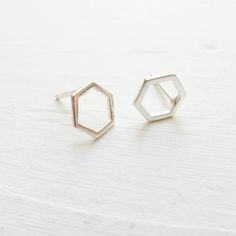 "Dainty sterling silver hexagon honeycombs are soldered to sterling silver studs to create these minimal earrings. . { m e a s u r e m e n t s } . ~ 1/3\" . { o p t i o n s } . Other Post Earring Styles: https://www.etsy.com/shop/CamileeDesigns?section_id=10245147&ref=shopsection_leftnav_3 . { p a c k a g i n g } . Your jewelry will arrive in a cute box - perfect for giving or keeping for yourself. . { s h i p p i n g } . Handmade in my studio and shipped via USPS mail with tracking. Please Minimalist Sterling Silver Octagon Jewelry, Minimalist Octagon Sterling Silver Jewelry, Minimalist Silver Octagon Jewelry, Minimalist Hexagon Sterling Silver Jewelry, Modern Sterling Silver Hexagon Jewelry, Minimalist Hexagon Faceted Jewelry, Honey Combs, Earring Styles, Bee Jewelry