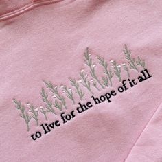 Embroidered light pink hooded sweatshirt with phrase "to live for the hope of it all" in black and white flowers with green stems  50% Cotton, 50% Polyester Each item is made to order so slight variations may occur Black And White Flowers, The Hope, For The, Pink Hoodie, Dream Wardrobe, Hooded Sweatshirt, White Flowers, Sweat Shirt, Hooded Sweatshirts