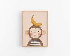 a monkey with a banana on top of it's head is mounted to the wall