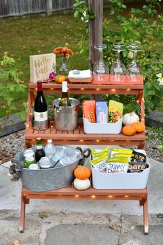 an outdoor bar cart with drinks and snacks on it