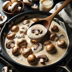 mushrooms being cooked in a skillet with a wooden spoon on the side and other ingredients nearby