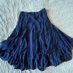 Calypso St. Barth ~ Christiane Celle Ruffled Renaissance Boho Fairy Skirt Midnight Blue Navy Vintage From 2000s 100% Silk Size 8 Nwot A Classy Skirt That Features Delicate Ruffles In Midnight Blue Silk Chiffon That Is Weightless And Absolutely Ethereal. The Color Is Sophisticated Deep Navy Blue That Can Be Worn To The Office With The Blue Calypso Button-Down I Have Listed Or A Comfy Tee For Weekend Brunch. It Fits Flat At The Waist And Then Flares Out At The Skirt. Beneath The First Ruffle Layer Silk Ruffled Flowy Skirt, Blue Flowy Party Skirt, Blue Flowy Skirt For Party, Flowy Blue Party Skirt, Chic Flowy Blue Skirt, Elegant Blue Maxi Skirt With Ruffles, Elegant Blue Ruffled Maxi Skirt, Blue Asymmetrical Maxi Skirt For Party, Blue Flared Chiffon Skirt