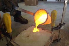 a man is working on something with yellow liquid