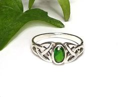 My Celtic Emerald Green CZ Gemstone ring was created in solid Sterling Silver. The front of the ring is set with an oval faceted Emerald green cubic zirconia cab and is framed with a Celtic Trinity knot on each side of the stone. The face of the ring measures 8mm or .31 inches. Please select your size from the drop down menu.~The color in this ring is a true Celtic or Irish green and is the birthstone for May.~The Celtic Trinity or Triquetra symbolizes the "Trine" or the "Three". It consists of Green Opal Promise Ring, Green Crystal Promise Ring For May Birthstone, Green Hallmarked Birthstone Ring For Promise, Green Birthstone Ring For Promise, Adjustable Green Crystal Promise Ring, Adjustable Green Crystal Ring For Promise, Garnet Earrings Silver, Emerald Green Ring, Silver Solitaire Engagement Ring