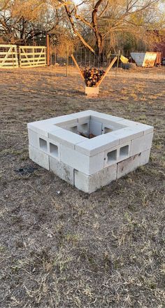 a cinder block sitting in the middle of a field