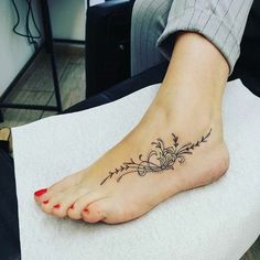 a woman with a tattoo on her foot