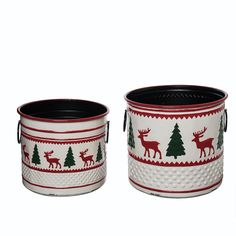 two white and red christmas tins with deer, trees and snowflakes on them