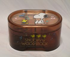 snoopy's wooden music box with musical notes on the front and back side