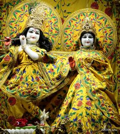 two women dressed in yellow and green with white face paint on their faces, sitting next to each other