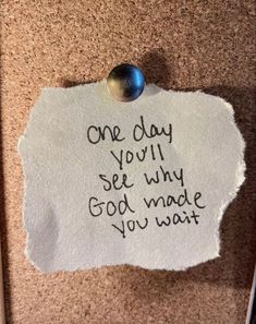 a piece of paper taped to the wall with writing on it that says, one day you'll see why god made you wait