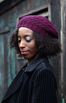 a woman wearing a purple knitted hat