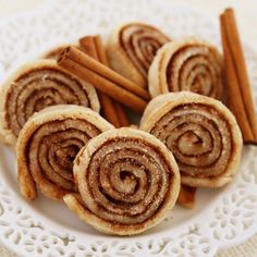 cinnamon rolls on a plate with cinnamon sticks