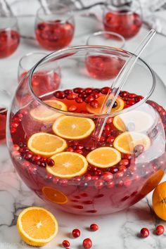 a bowl filled with oranges and cranberry punch