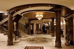 a large foyer with chandelier and marble flooring in an upscale home setting