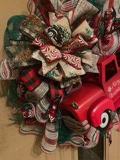 a christmas wreath with a red truck on it