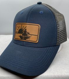 Life is good -Kayaking & Sunsets Leather Patch Hat Adjustable snapback closure One size fits most Unisex Hat Headmost Structured Hat Ships Fast Each piece of leather will vary.. no two pieces are the same All leather patches are glued with a high quality professional glue and placed on a heat press @ 320 degrees The hat is shown in a glued finish & stitched finish ( in addition to the glue) please choose your finish at check out. Wholesale Availability Adjustable Hats For Baseball Season, Adjustable Casual Snapback Hat With Leather Patch, Adjustable Baseball Cap With Logo Patch For Camping, Leather Baseball Cap For Outdoor Activities, Outdoor Baseball Season Hat With Logo Patch, Adjustable Navy Hat For Outdoor, Casual Adjustable Fitted Hat With Leather Patch, Casual Leather Snapback Hat Adjustable, Leather Patch Baseball Cap For Outdoor Activities