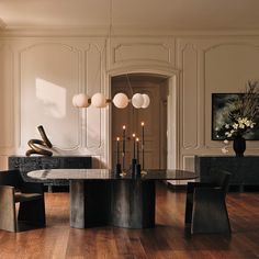 an elegant dining room with wooden floors and white walls