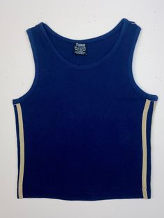 Trax brand super soft navy 1970's sport tank top with 3 khaki stripes on each side. Great condition! Made in Hong Kong.Label: TraxMaterial: 60 cotton / 40 polyester Size: Kids 10Chest: 29"Pit to Pit: 14.5"Sleeve: N/A, arm opening 7”Length from midway of top shoulder seam: 18”All of our shirts are authentic and sold as is. We accept light wear and tear as part of the beauty of age and comfort. Any major issues will be noted. Visit our website for more special finds www.honeypotvintage.com Sporty Striped Sleeveless Top, Sporty Sleeveless Striped Tops, Navy Sporty Top With Three Stripes, Sporty Cotton Tank Vest, Cotton Workout Tops With Three Stripes, Sleeveless Cotton Tank Top With Contrast Stripes, Cotton Sleeveless Tank Top With Contrast Stripes, Sporty Striped Sleeveless Tank Top, Navy Fitted Top With Contrast Stripes