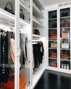 the closet is full of clothes and handbags