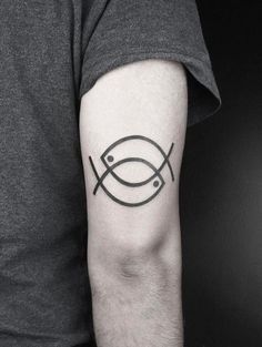 a black and white photo of a man's arm with a fish tattoo on it