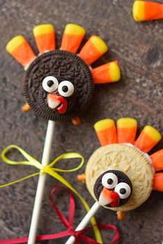 two cookies and candy sticks decorated to look like turkeys