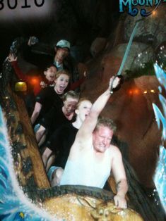 a group of people riding on top of a water slide