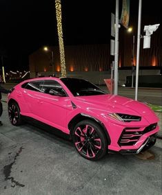 a pink lamb suv parked in front of a building