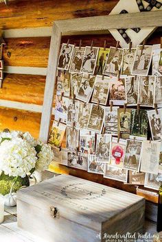 a wooden box sitting on top of a table next to a vase filled with flowers