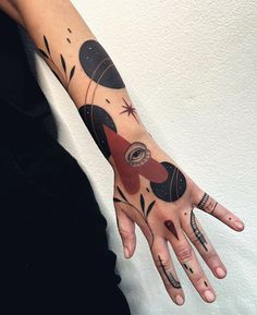 a woman's hand with tattoos on it