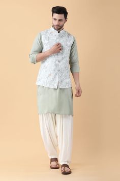 Mint green bundi crafted in ruby cotton silk with all over spring fleur print. Paired with a plain cotton silk kurta and cotton rayon salwar pant. - Aza Fashions Collar Kurta, Salwar Pants, Kurta Set For Men, Nehru Jackets, Green Spring, Manish, Kurta Set, Full Sleeves, Pants Pattern