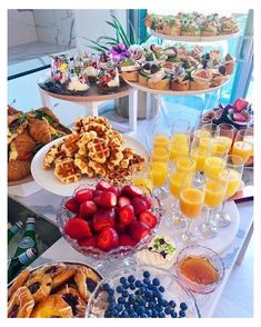 an assortment of desserts and pastries on a buffet table