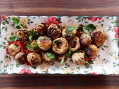 a white plate topped with mushrooms and tomatoes