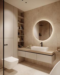 a bathroom with a round mirror above the sink and toilet in front of it is illuminated by lights