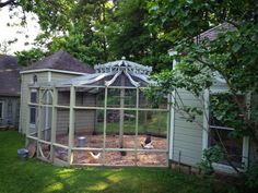 a backyard area with a chicken coop in the middle