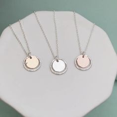 This dainty handmade necklace is perfect for everyday.  Your choice or mixed metal or solid silver, it features a gently hammered silver ring paired with your choice of a smooth or hammered center coin. * PENDANT MEASURES APPROX. 1/2"/12mm IN DIAMETER. * Your choice of length and center coin finish (smooth or hammered) at drop-down when adding the necklace to your cart. * HANDMADE FROM STERLING SILVER and 14K GOLD FILLED METALS * Complimentary first-class USPS shipping with tracking. You can upgrade to Priority Mail for an additional $5. * Packaged with lots of love in a small jewelry box and drawstring pouch.   15% off your first Remy and Me. order  Visit: tinyurl.com/2xvdeecr  to subscribe to my newsletter and get the code to apply at checkout.  THANK YOU FOR SHOPPING SMALL Always feel f Hammered Silver Ring, Small Jewelry Box, Drawstring Pouch, Everyday Earrings, Hammered Silver, Small Jewelry, Coin Pendant, Handmade Necklace, Everyday Jewelry