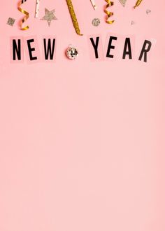 the word new year spelled out with confetti and streamers on a pink background