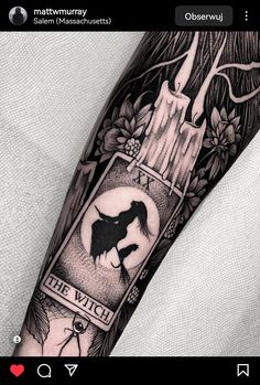 a black and white tattoo on the arm of a person with a wolf in it