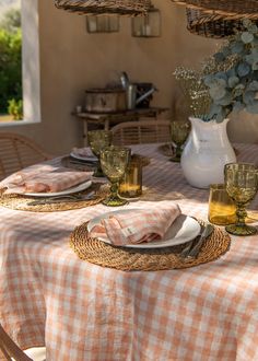 the table is set with plates and glasses