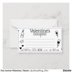 a valentine coup card with wine glasses and hearts on the front, sitting on a marble surface