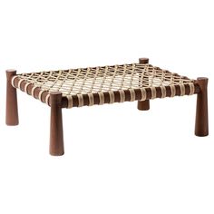 a woven table with wooden legs on white background