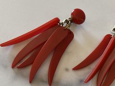 "Red Hot Chili Peppers Vintage Bakelite dangle earrings. These earrings are a whopping 3.25 inches long. Each pair has 5 dangling \"peppers\" and has a small round disc on the clip back. Clip backs have new foam comfort pads. These are from my private collection and I always preferred the fit with the comfort pads, they are entirely removable. Awesome pepper red, difficult to capture exactly but very close. On my computer monitor the 1st photo is the closest to correct coloring. Please contact m Red Vintage Dangle Chandelier Earrings, Vintage Red Dangle Chandelier Earrings, Red Vintage Chandelier Dangle Earrings, Red Dangle Clip-on Earrings For Formal Occasions, Formal Red Dangle Clip-on Earrings, Bakelite Jewelry, Hottest Chili Pepper, Buckle Bracelet, Red Hot Chili Peppers